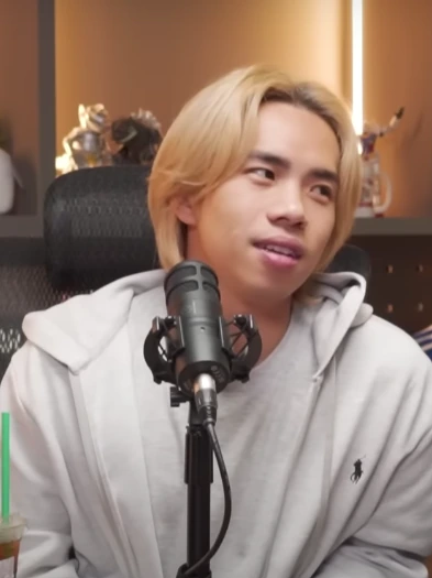 JianHao Tan speaking into a microphone in a studio setting