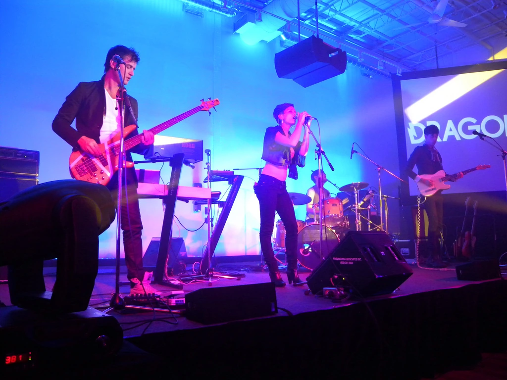 Dragonette performing live on stage in blue and purple lighting
