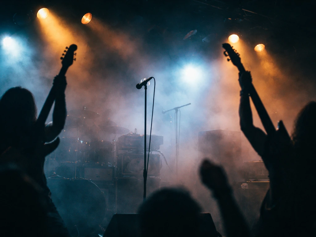 Dark concert stage with silhouettes and instruments, suggesting music industry earnings and deals