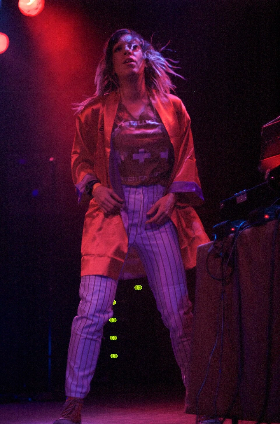 Lady Starlight performing on stage under colored lights